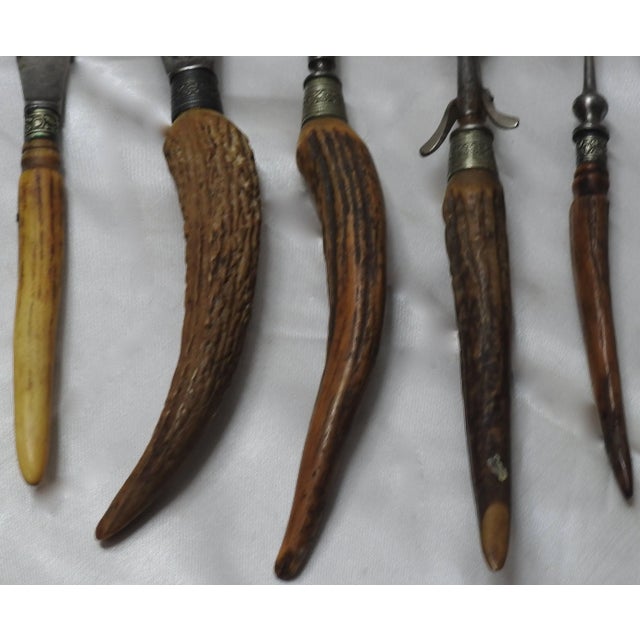 We are offering an antique horn handled carving set with five pieces. The set features a honing blade, carving knife, two...