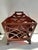 A single antique reticulated wood magazine rack or newspaper holder with handle and feet. Features chippendale style...