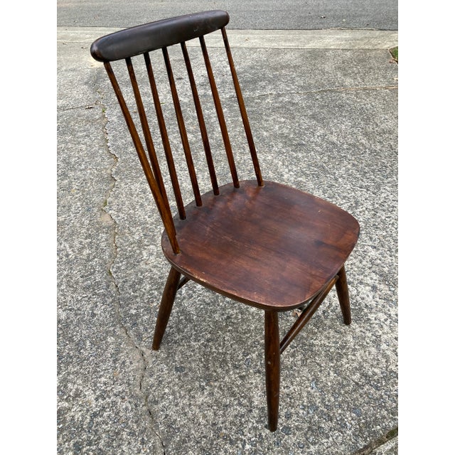 A beautifully constructed dark glazed spindle back dining chairs most likely originating from Scandinavia and dating from...