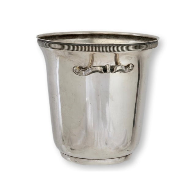 A handsome midcentury French silverplate champagne bucket with elegant ring handles and a clean, timeless profile. Marked...