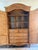 A substantial vintage Drexel Heritage armoire with elegant French Provincial styling, richly carved detailing, warm wood...