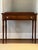 An attractive antique cherry side table from New York State. The side table has a rectangular top, above a single frieze...