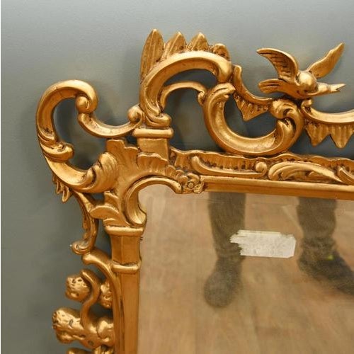 Very decorative carved giltwood overmantel mirror in the Georgian Rococo style Elaborately pierced frame with scrolling...
