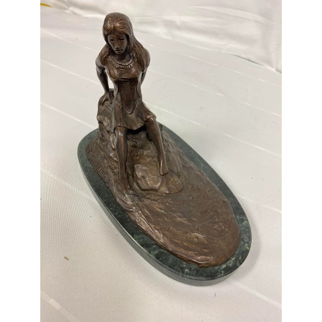 Robert J Bealer bronze entitled "just thinkin" depicts Indian maiden on a rock. Mounted on green marble. Signed.