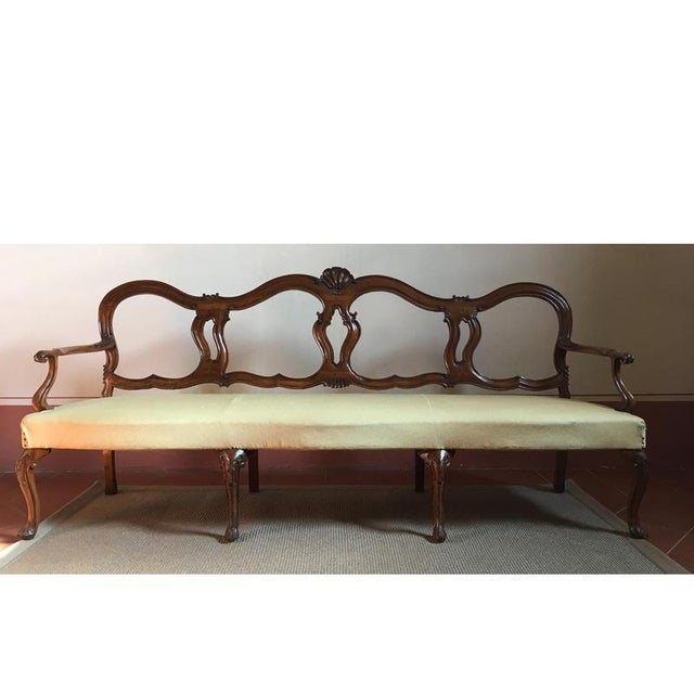 Mid-18th Century hand-carved 1750 Venetian Baroque walnut sofa, three-seat with armrests. Remarkable work by Venetian...