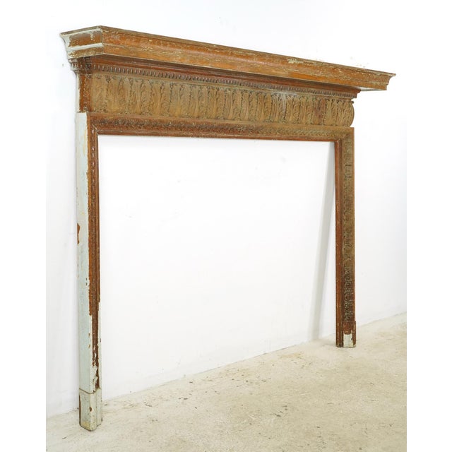 Georgian style wood fireplace surround with dentil molding and carved acanthus leaves. Fair condition with heavy surface...