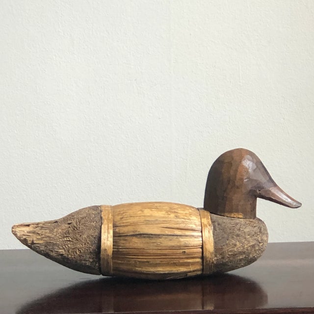 A beautiful piece of primitive folk art, this handcrafted duck decoy is constructed of cork straw and corn husk and has a...
