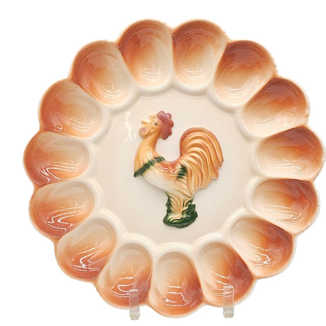 A playful farmhouse platter, crafted in ceramic, with a bold rooster at its center and scalloped wells circling its form....