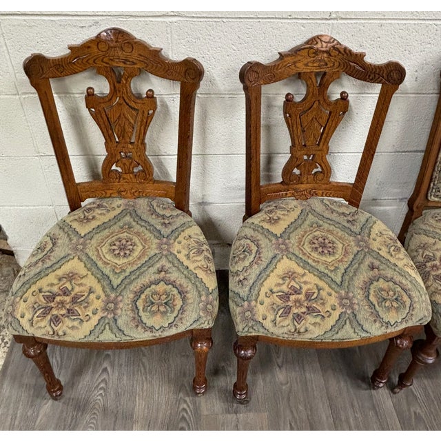 This is a gorgeous set of 6 antique Victorian upholstered oak and tapestry dining chairs, including 4 carved side chairs...