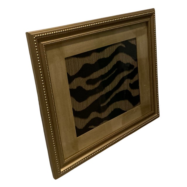 A bold, tactile art piece featuring Schumacher’s luxurious Regine Stie velvet textile, framed in a recycled gold frame and...