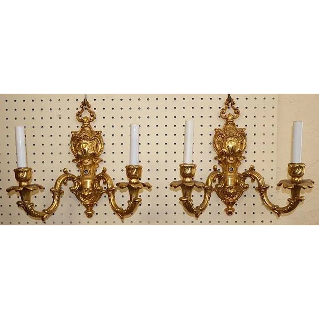 Stunning Pair of Gold Dore Bronze Two Light Sconces By FBAI Dimensions : 13" Tall X 14" Wide X 6" Deep This gorgeous pair...