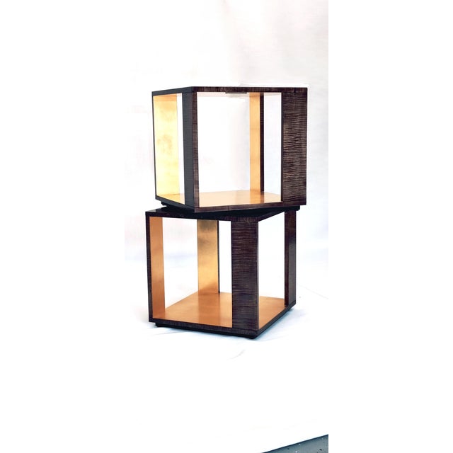 Magnificient pair of side tables in pale grey fruitwood veneer with gold leaf interiors. Timeless style with a cubist...