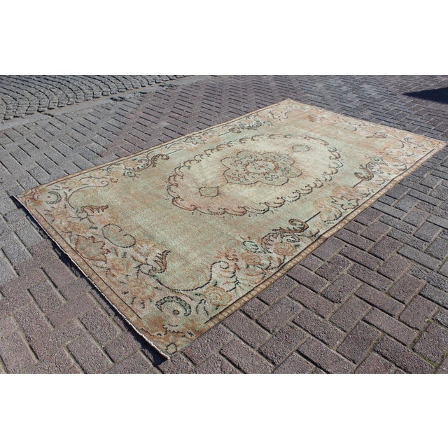This beautiful, traditional vintage, hand knotted Turkish area rug is approximately 60 years old. It is handmade of very...