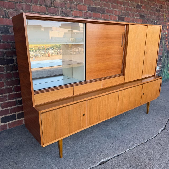 Gorgeous and ready to ground any mid-century living room, this German made hutch has more than ample storage; 3 shelving...