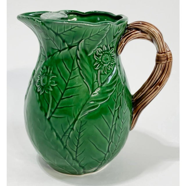 Vintage Majolica style green pitcher decorated with foliate and floral motif with grapevine design to handle. Nice leaf...