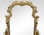 Italian giltwood and figured walnut dressing mirror of Rococo style, the long scrolled foliate frame mounted on scrolled...