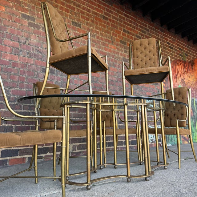 This is a stunning Mastercraft brass and glass dining set from the 1970s. It features a beautiful clear glass top to...