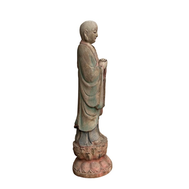 This is a Chinese decorative wooden standing praying Lohon monk statue. It is finished in a vintage rustic look....