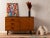 Classic chest of drawers from the 1960s. Corpus in teak veneer with four drawers, one door, one shelf and tapered feet....