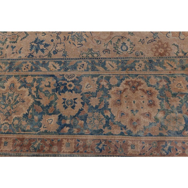 An early 20th century antique carpet, the camel field with a subtle allover trellis of palmettes, flowering vine and...