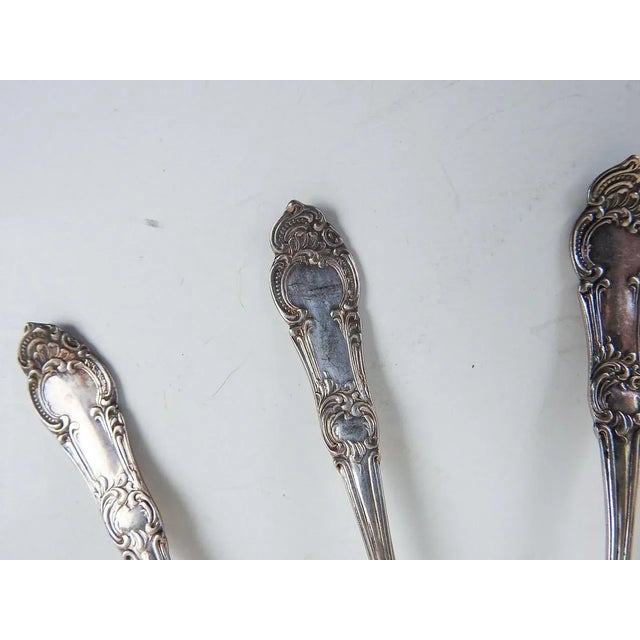 Set of 5 antique silver plate demitasse spoons. Marked L.T. A.I. on back, overall patina.
