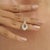 Crafted in 925 sterling silver, this elegant open teardrop pendant features 0.69 carats of round-cut moissanite in a...