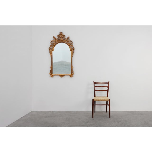 Dating back to the mid-20th century, this large and imposing Baroque-style mirror by the renowned Belgian manufacturer...