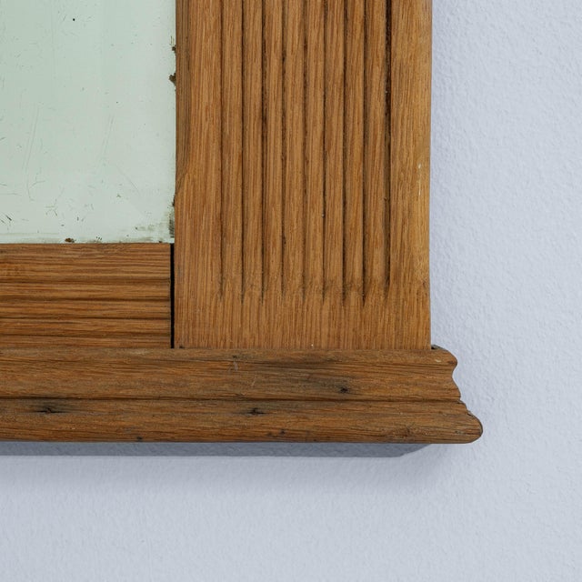 This elegant French mirror from the 1880s reflects the restrained symmetry and architectural clarity of the Neoclassical...