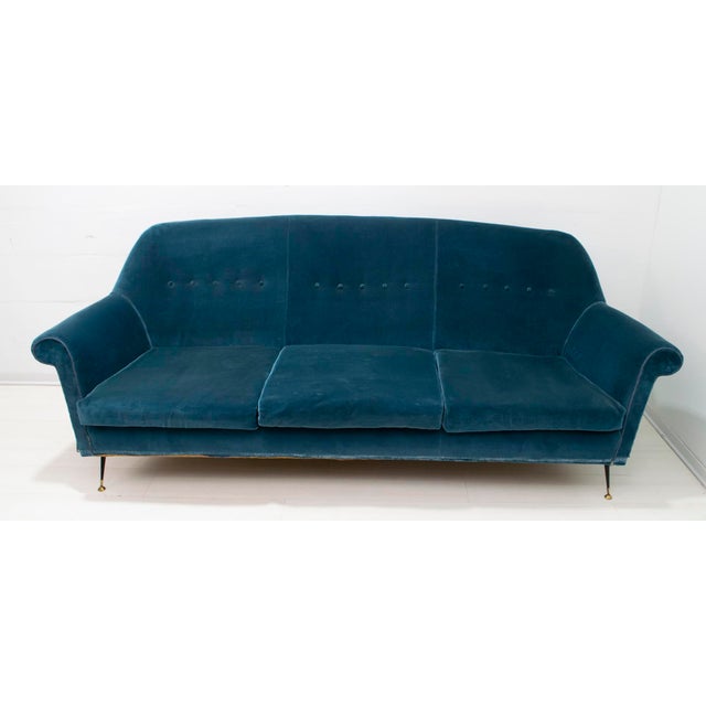 Sofa designed by Gigi Radice for Minotti. Made with a solid wood frame and blue velvet upholstery, with brass and black...