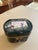An exceptional antique lidded box made of green glass with delicate hand-painted enamel decoration. This decorative box...