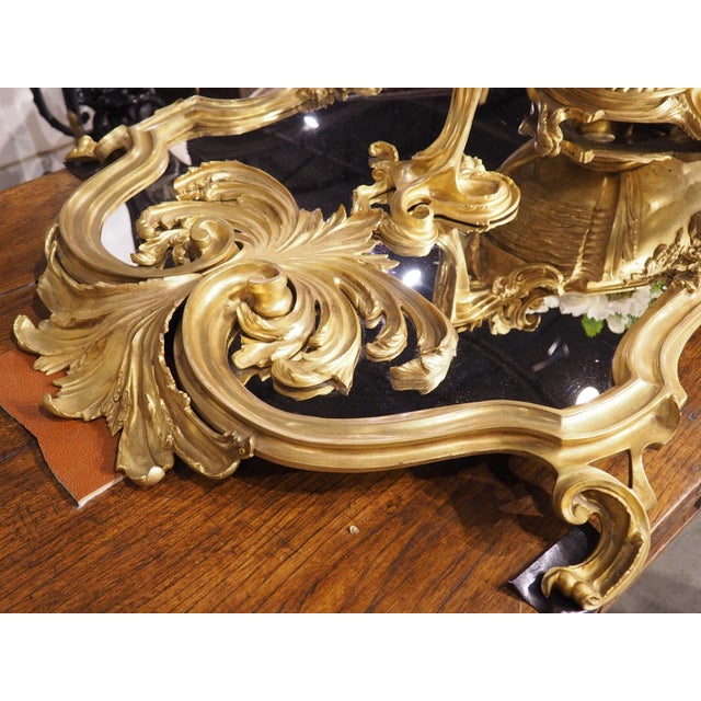 Measuring 74 ½ inches long, this palatial gilt bronze mirrored surtout de table would make a wonderful centerpiece for a...