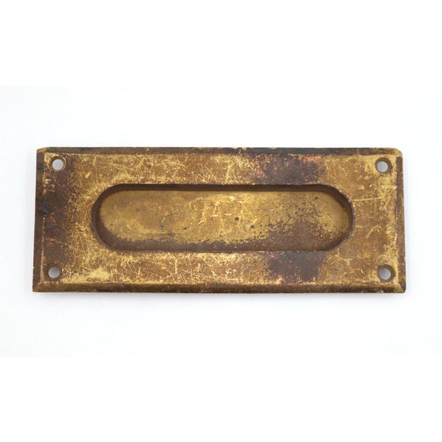 Vintage spring loaded mail slot that opens inward at 45 degrees to allow mail through. Made of brass with a patina finish....