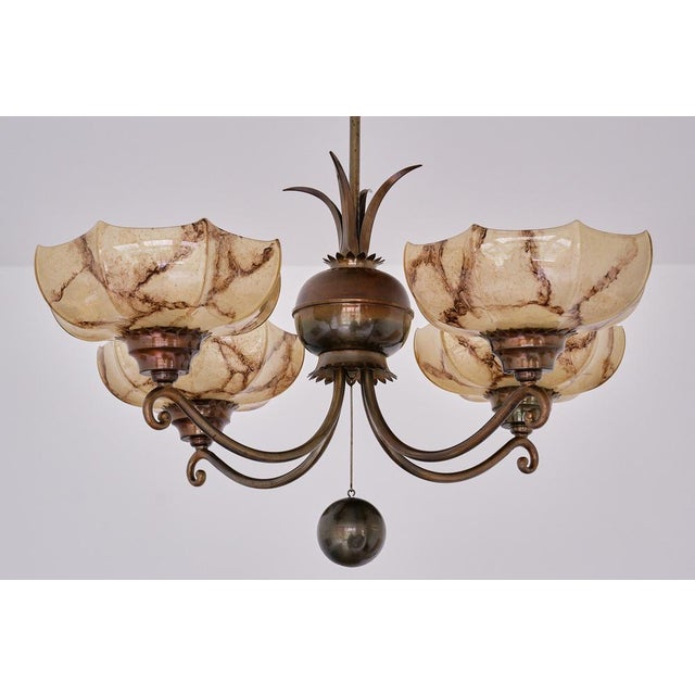 This striking four arm chandelier was designed by Harald Notini and produced by Arvid Böhlmarks Lampfabrik in Sweden,...