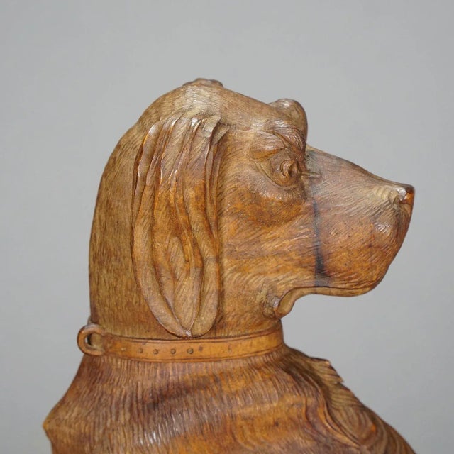 A wooden carved statue of a staghound. Carved as half relief out of one piece of nutwood. Brienz, Switzerland, circa 1920....