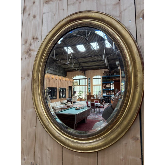 Oval wall mirror, Napoleon III period, circa 1860-1880, gilded with gold leaf on a wood and stucco backing. The frame...