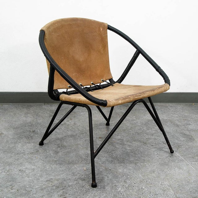 Black metal side chair with a leather sling-style seat and backrest. Recently imported from Denmark. Unmarked example.