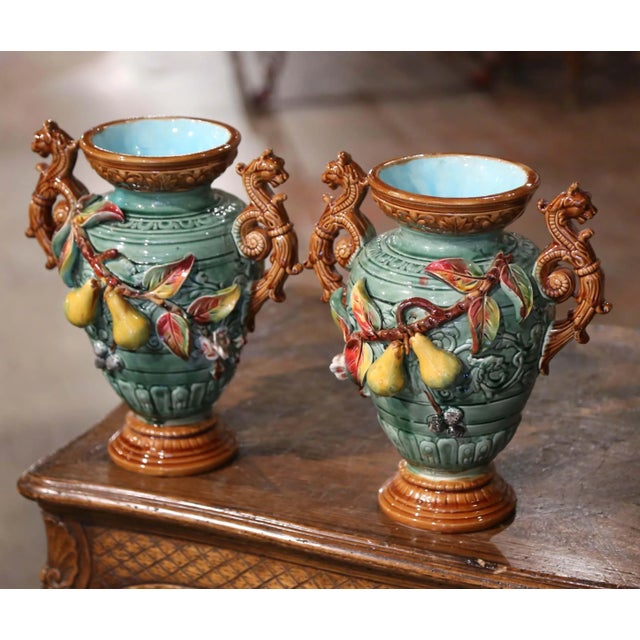 Bring colors to your mantel with this pair of antique Majolica vases with fruit motifs. Crafted in Southern France, circa...