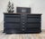 Mid-Century Modern finished in Black with Walnut Trim. Silver knobs and handles. 6 drawers with walnut and silver accents....