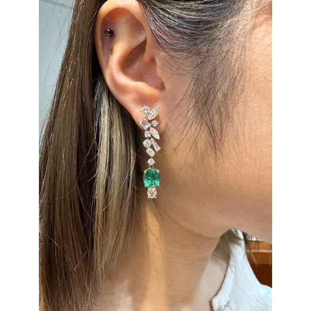 18K Yellow and White Gold detachable drop earrings. Featuring a symphony of natural emeralds and diamonds. Set with two...