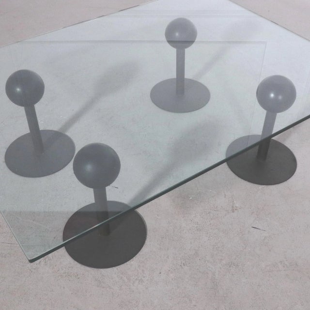 Rare coffee table, designed by Philippe Starck in 1982 for Les Trois Suisses. This table was made of 4 black metal bases...