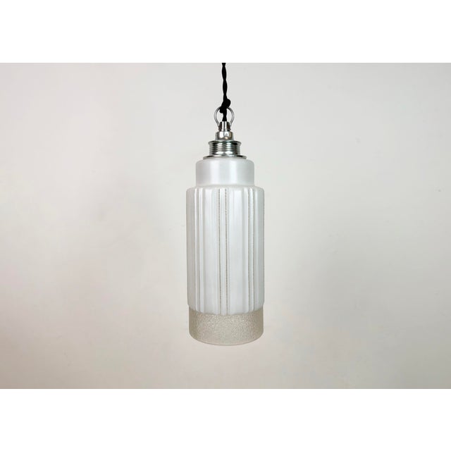 Vintage milk glass ceiling light made in former Czechoslovakia during the 1970s. The metal socket requires standard...