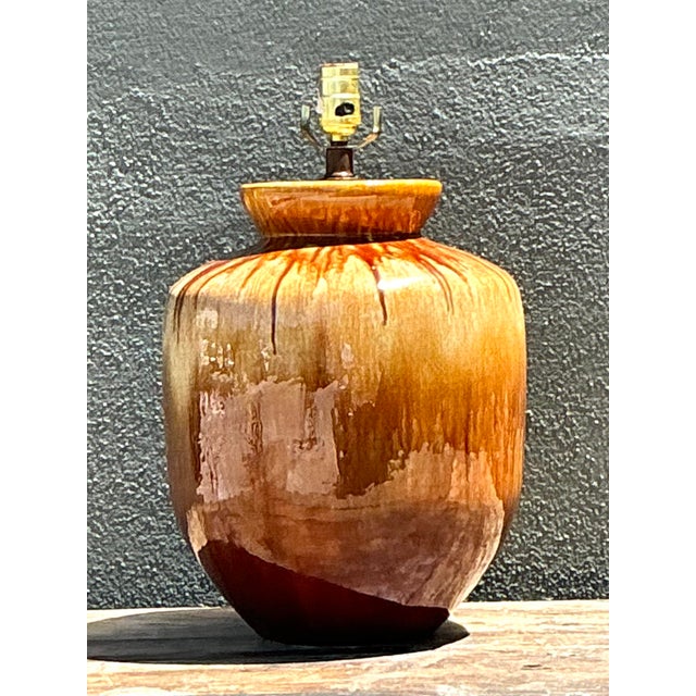 This stunning pair of Mid-Century Modern table lamps showcases the expressive beauty of the drip glaze technique, a...