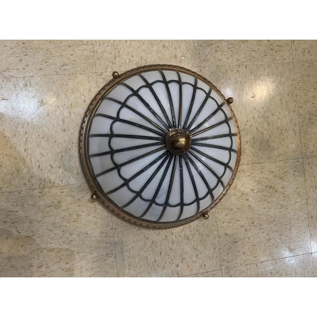 Circa 1900 leaded glass with brass light fixture. Beautiful set of light fixtures. Could be used flush mounted or hanging.