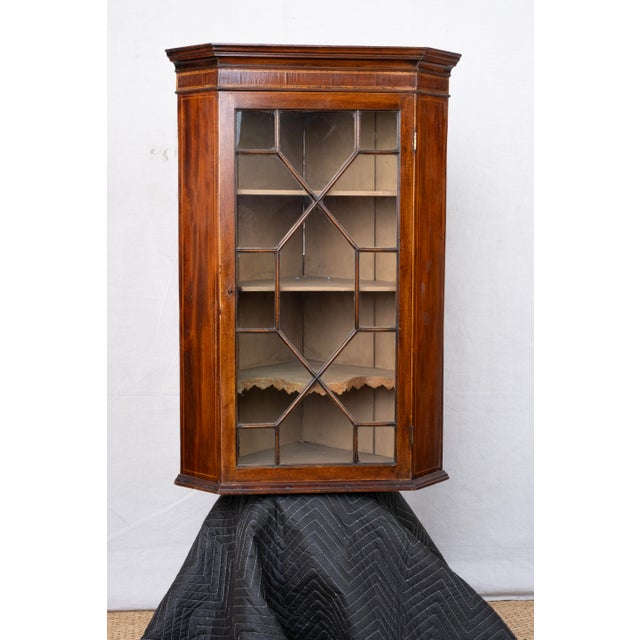 A wall mounted corner cabinet, late 18th century, English, attributed to Thomas Chippendale. Made from mahogany and...