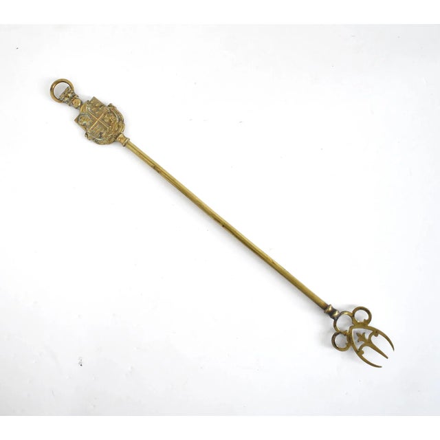 An antique, English brass toasting fork with the Bournemouth coat of arms: Pulchritudo et Salubritas, with rampant lions,...