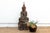 This antique wooden sculpture of the Buddha, depicted in a serene meditative pose, exudes an aura of tranquility and...