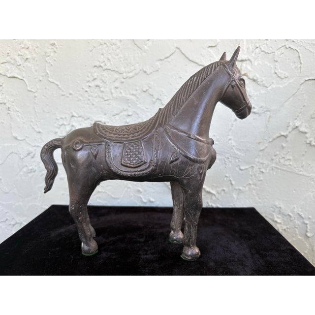 This striking vintage horse sculpture is finely cast in solid metal and features beautifully detailed ornamental saddle...