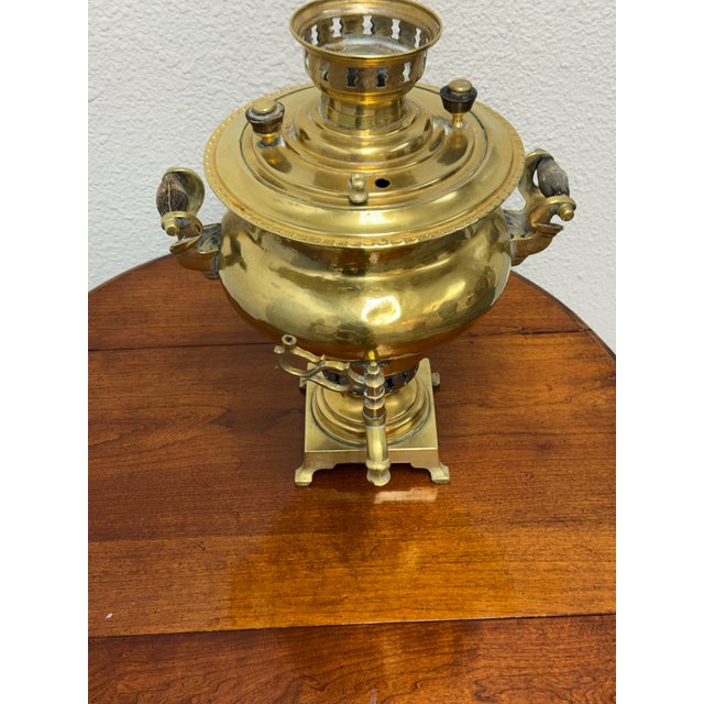 Design Plus Gallery presents a Russian Brass Samovar. This antique brass vessel has a rounded urn-form body, raised lid,...
