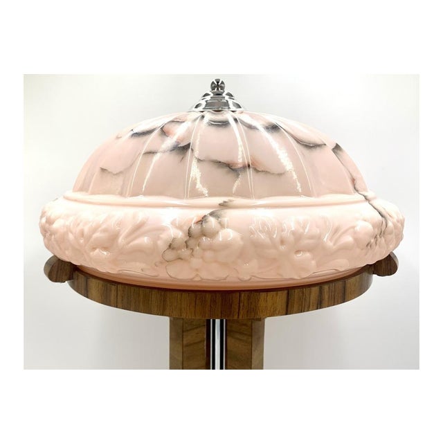 Art Deco table lamp with a large decorative pink shade. Made in Poland in the 1950s. The posture will be made of walnut...