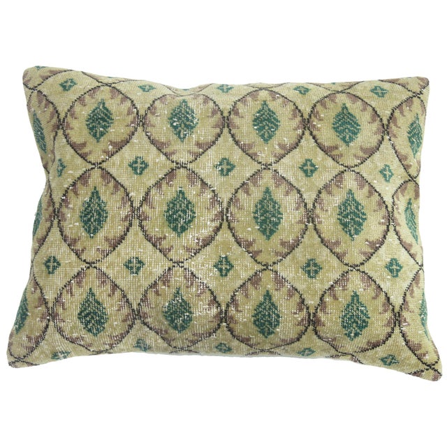 Large pillow made from a Turkish rug with a solid cotton back and zipper closure. Foam fill. Beige green mauve accents....